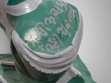 a green and white statue of a shoe with writing on it