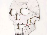 a skull made out of paper with a hole in the middle