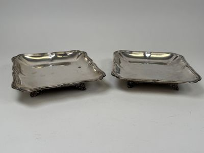 a pair of silver plated dishes on stands