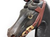 a wooden horse head with a bridle on it ' s head
