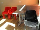 three chairs and a table in the corner of a room