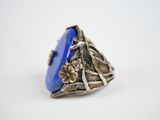 a close up of a ring with a blue stone in it