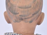 a doll head with a tattoo on the back of it