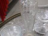 a lot of glass vases on a table with a picture frame