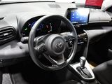 the interior of a car with a steering wheel, dashboard, and display screen