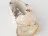 a small figurine of a boat with sheep in it