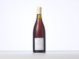the bottle of wine is sitting on the table with a white background