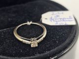 a ring with a diamond on it in a case