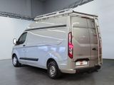 a white van parked in a large room with a ladder on the roof