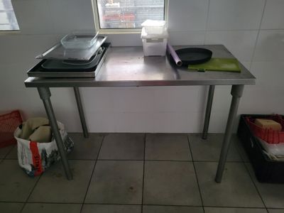 a table with two pans on top of it in a kitchen