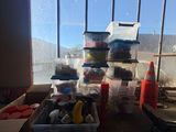 a table with a lot of stuff on it in front of a window