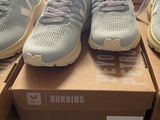several pairs of running shoes are on a box in a store