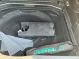 an open trunk of a car with a laptop in it
