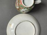 a small cup and saucer sitting on a table