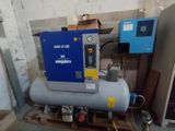 a blue machine that is sitting on a pallet in a room