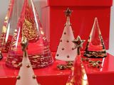 a lot of christmas trees that are on a red table
