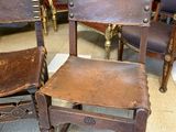 pair of antique wooden chairs with leather upholstered seats