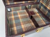 a brown suitcase with a plaid pattern inside of it