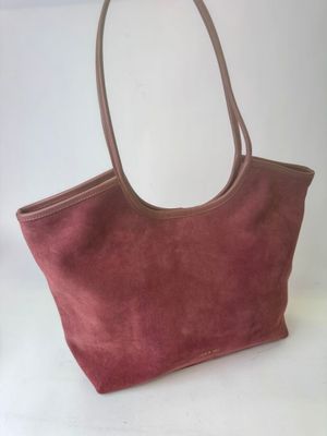 a close up of a handbag on a table with a white background