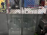 an image of a glass enclosed shower stall in a store