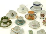 a lot of tea cups and saucers sitting on a table