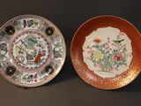 two plates with different designs on them sitting on a table