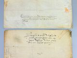 two old papers with writing on them sitting on a table