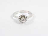 a close up of a diamond ring on a white surface
