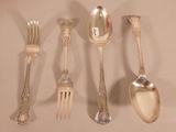 five silver spoons and two silver spoons on the table
