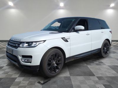 a white land rover parked in a large room with checkered floor