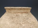 a vase that is sitting on a table with a blue background
