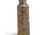 a brown vase that is sitting on a white surface