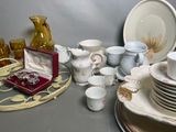 a lot of dishes and cups on the table
