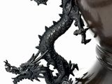 statue of a dragon on a vase on a white background
