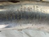 a silver plate with writing on it on a table