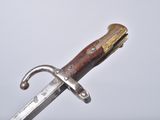 an old knife with a wooden handle on a white surface