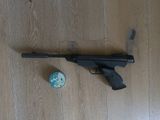 a gun and a ball on the floor next to it