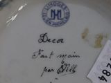 a white plate with writing on it with a tag on it