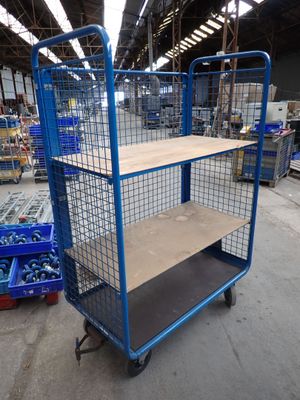 blue wire mesh shelf cart with shelves in warehouse