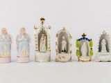 seven figurines of different sizes and colors