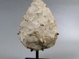 an image of a stone object on a black stand
