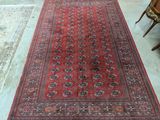rug on the floor in front of a chair and a table