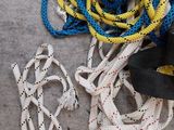 a pile of rope and a pair of scissors on the ground