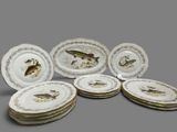 six plates with fish designs on them sitting on top of each other