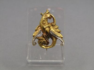 a gold ring with a bird and a snake on it