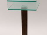 a close up of a glass table with a wooden base