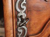 a close up of a door handle on a wooden door