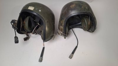two helmets that are sitting on a table