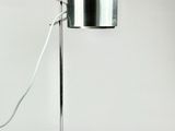 a lamp that is on a metal stand with a cord