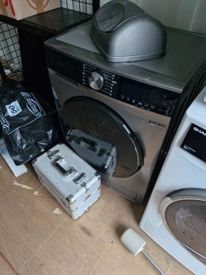 a washer and dryer sitting on the floor next to each other